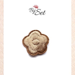 Bruin bloem op antislip knipje voor baby's of fijne haartjes